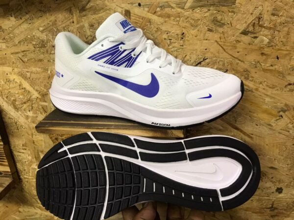 White Nike Zoom sports shoes